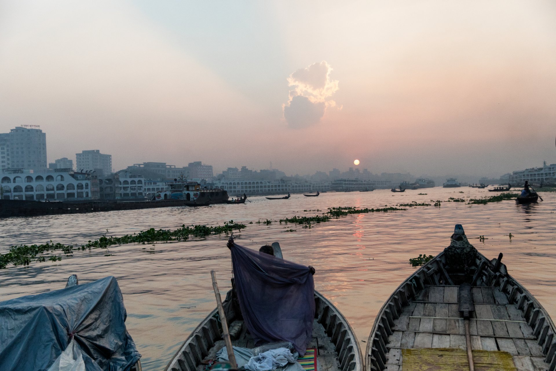 Boat driver with a mosquito net at Keraniganj port on the Buriganga river