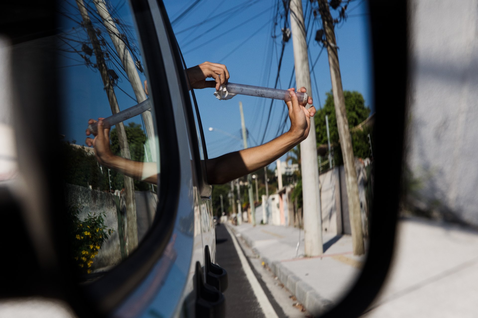 Man releasing a tube of mosquitoes that carry Wolbachia from his car window