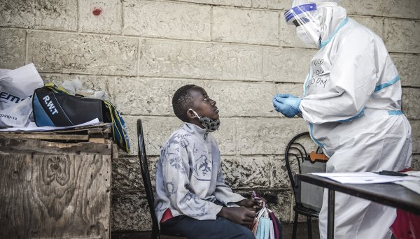 A young boy selling face masks in the streets of the Kawangware slums, in Kenya, is being tested for coronavirus.