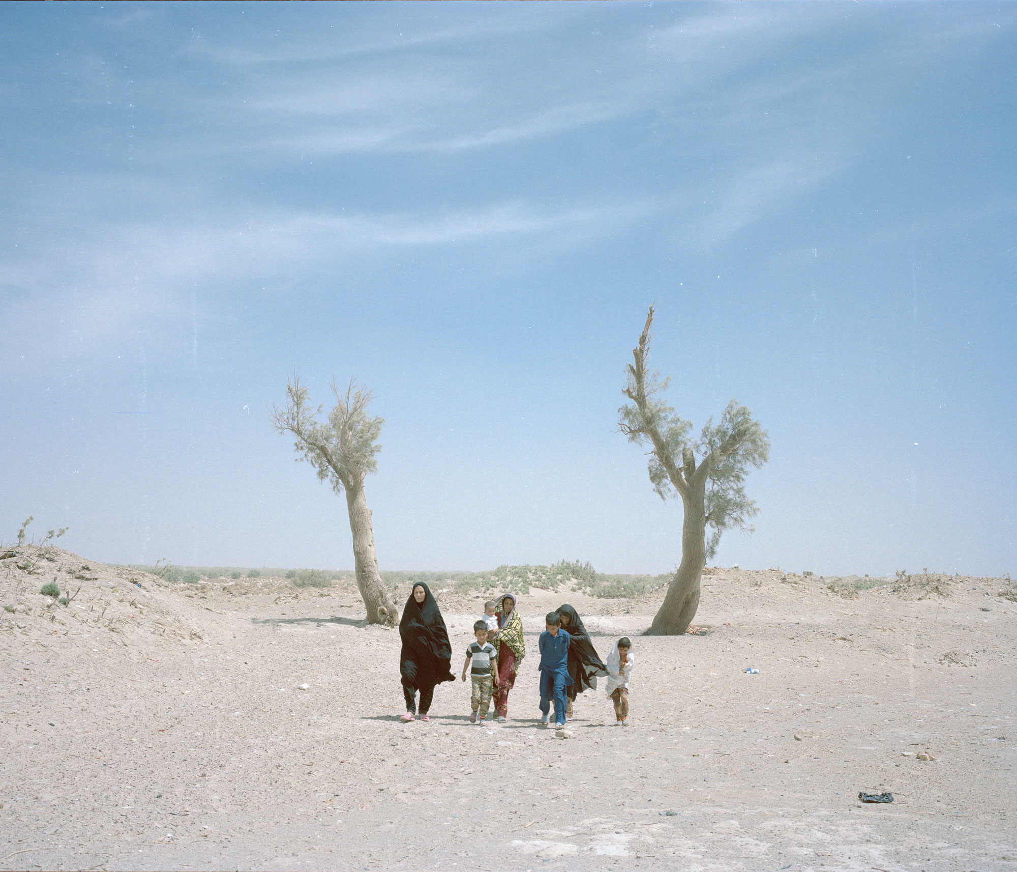 The Saravani family walk in the Sistan and Baluchestan region in Iran, now an infertile desert.