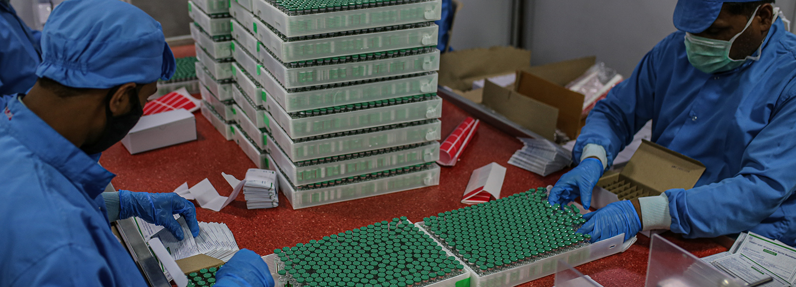 Employees packing boxes with COVID-19 vaccine at the packaging and dispatch department in Pune, Maharashtra, India