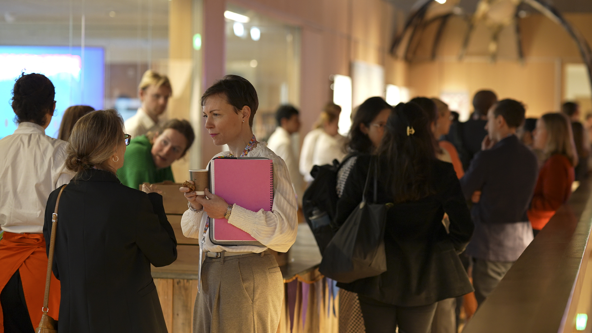 A group of people in conversation in a dimly lit room at the Policy Lab Festival 2024 