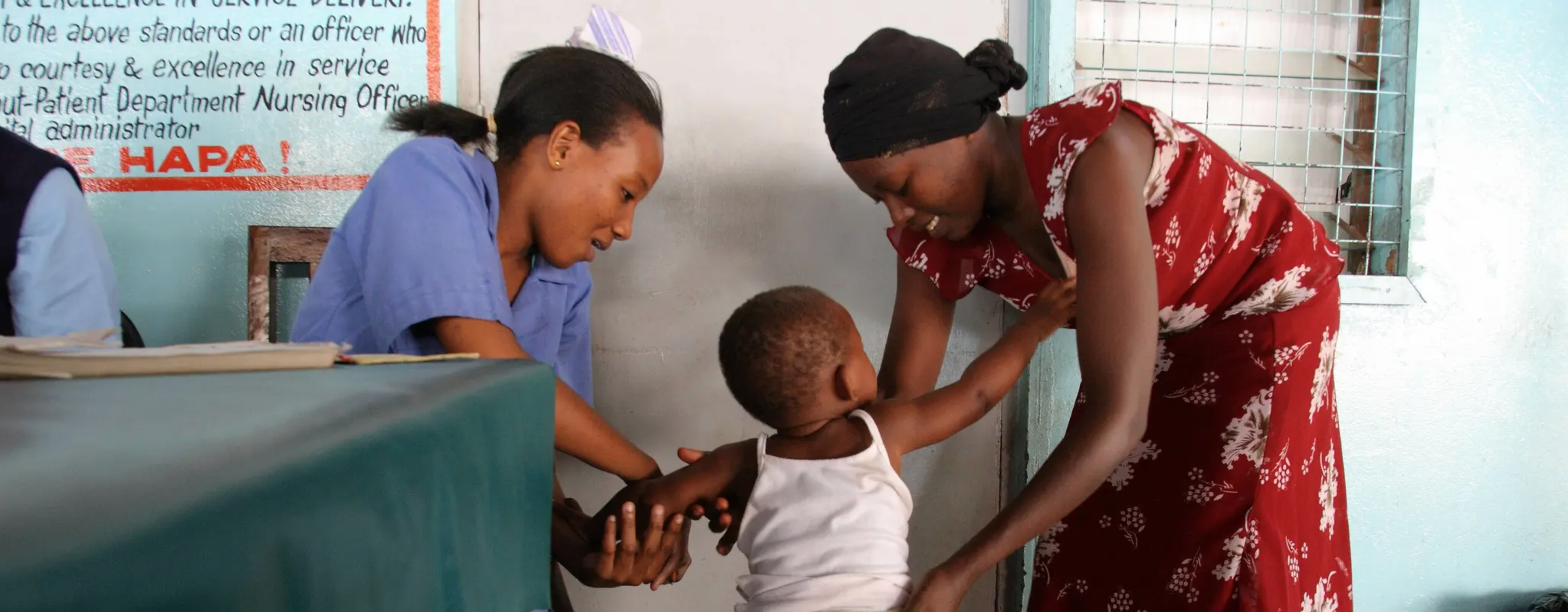 A child has her weight taken at the malaria vaccination ward at the Kilifi County referral hospital Outpatient Department in Kilifi, Kenya.