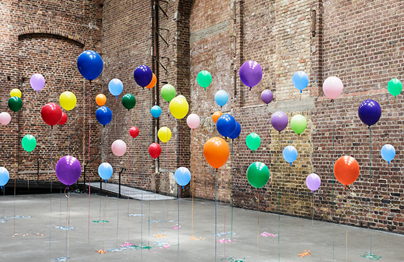 Colourful balloons in empty warehouse (Image © Anthony Harvie/Getty Images)