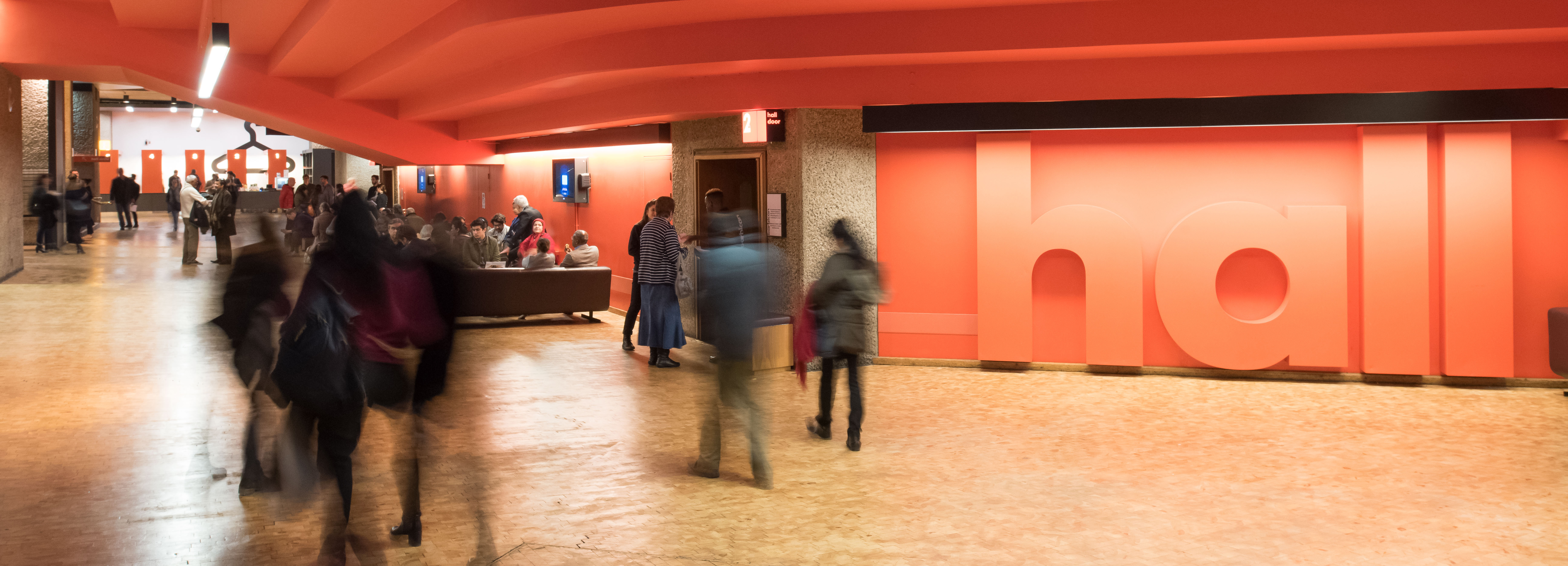 People standing in the foyer at the Barbican Centre