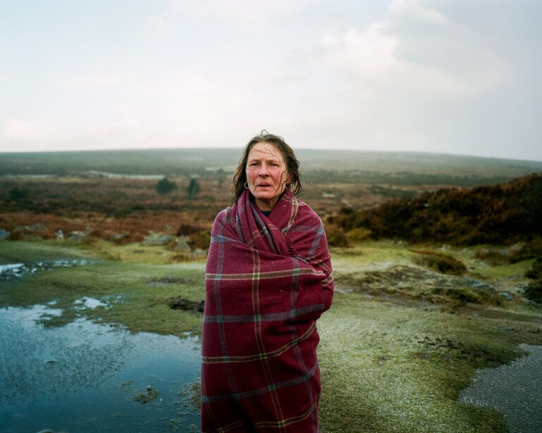 A woman walks on the moors close to her home.