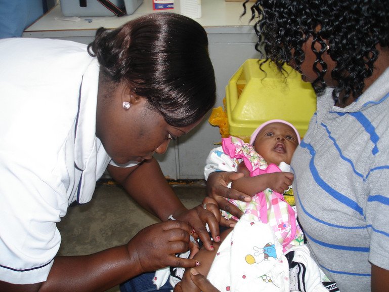 A healthcare worker gives a child the RTS,S malaria vaccine.