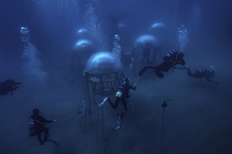 Solar panels on land send all the energy the biospheres need via underwater cables.