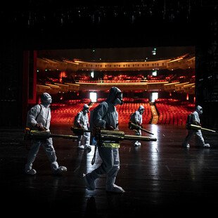 Volunteers dressed in hazmat suits disinfect the Qintai Grand Theatre in Wuhan, Hubei province.