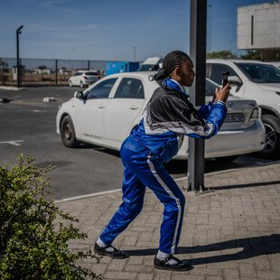 A learner shoots footage in a carpark during a creative documentary making workshop.