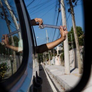 Man releasing a tube of mosquitoes that carry Wolbachia from his car window.