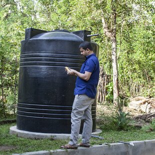 Upul tests the water in the village water tank