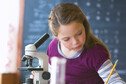 Young child in classroom with microscope