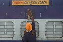 A worker cleans the exterior of a train coach that has been converted into a Covid-19 isolation ward.