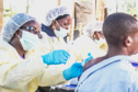 A healthcare worker gives a man an Ebola vaccination