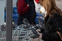 Woman wears face mask and pushes shopping trolley