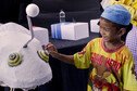 A boy in Bangkok strokes a puppet in a play about antimicrobial resistance