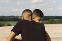 Two brothers hug in a park a few days after lockdown restrictions were eased.