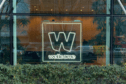 Neon Wellcome logo in window