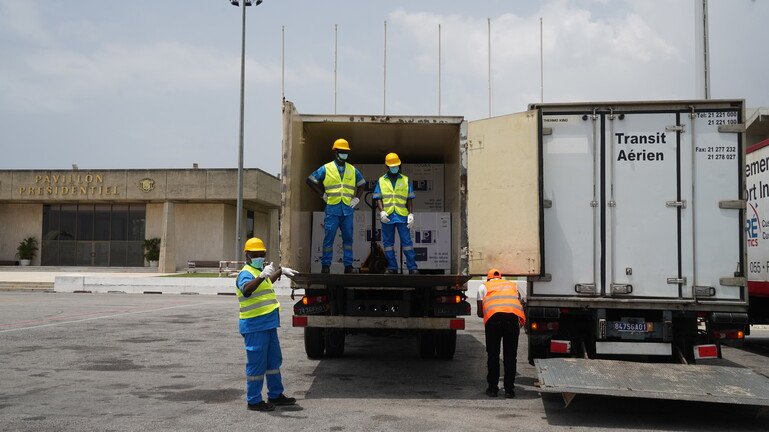 Boxes of the Covid-19 vaccine are loaded onto a truck.