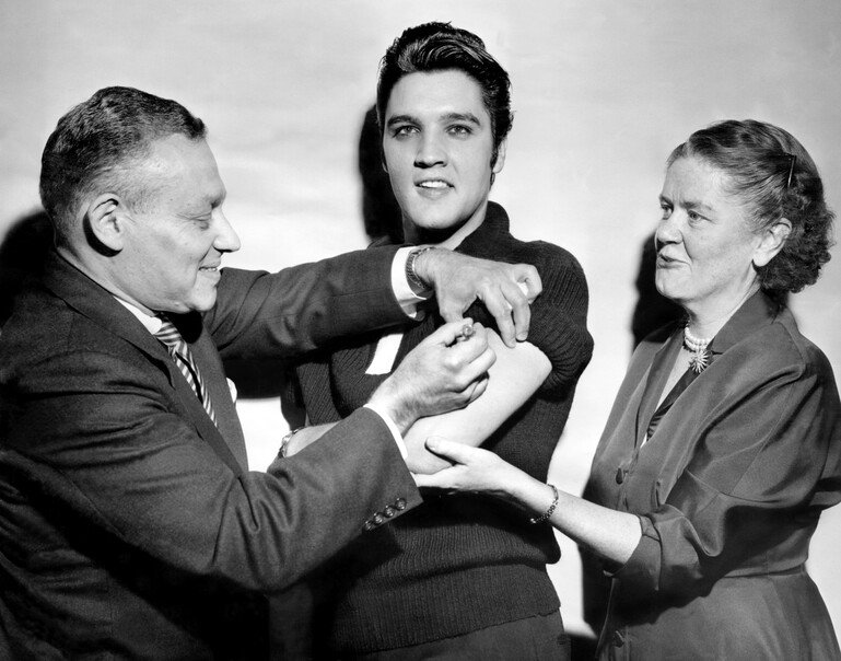 Elvis Presley receiving a polio vaccination.
