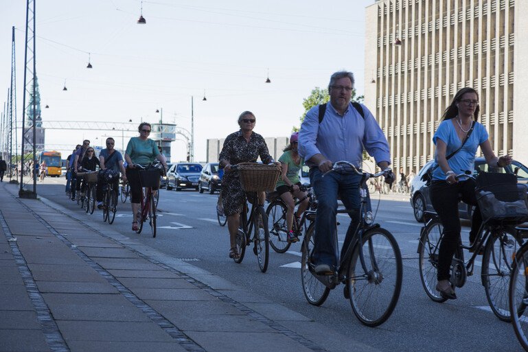 A road in the city of Copenhagen, Denmark is busy with cyclists commuting into the city.