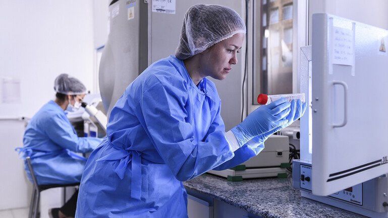 A biologist takes coronavirus DNA sample from the freezer.