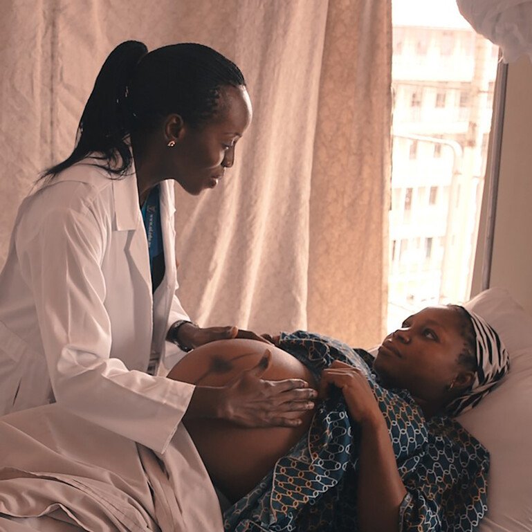 A pregnant woman in Niger being checked by a woman doctor.