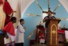 Scientific communicator from the World Mosquito Program explaining the Wolbachia mosquito method to congregation in Sao Sebastiao church