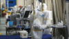A medical staff member disinfects medical equipment in a ward