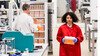 A researcher wearing a red lab coat in the Sequencing Centre at the Wellcome Sanger Institute