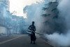 A man sprays the streets of Uttara, a town in the northern suburbs of Dhaka, Bangladesh.