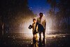 A boy and his grandfather walk through flood waters back to their family home, which they and their relatives evacuated days before floods hit.