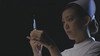 A female nurse holds up a vaccine.