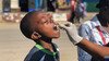 A young boy receives the oral cholera vaccine.