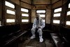 A tram conductor in Kolkata, India, wears protective clothing from head to toe during the Covid-19 pandemic.