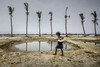 A girl carries water for her family, in a remote village in West Bengal, India. 