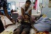 Young boy with dengue lying in a hospital bed