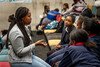 A girl with long hair speaks to a small group of girls during an AMR workshop in Khayelitsha, South Africa.