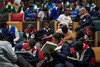 A group of young learners sitting in a theatre-like conference room. They are jotting down notes during an AMR workshop in Khayelitsha, South Africa.