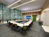 An example committee room, with a screen against the far wall and chairs and tables arranged in a U-shape.