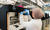 A researcher at Wellcome Sanger Institute examines their project in a lab.