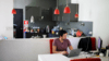 Male researcher sits at desk in his kitchen and looks at laptop