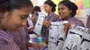 Schoolchildren in India show the comics they produced.