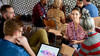 Four people have a discussion sitting in a circle 