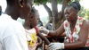 A girl gets a vaccination against measles from a health worker 