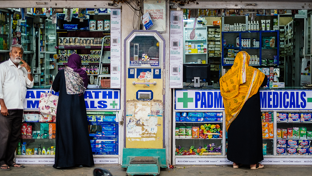 People outside a pharmacy in India.